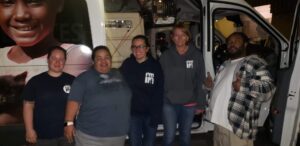 Michelle George standing with her former collegues